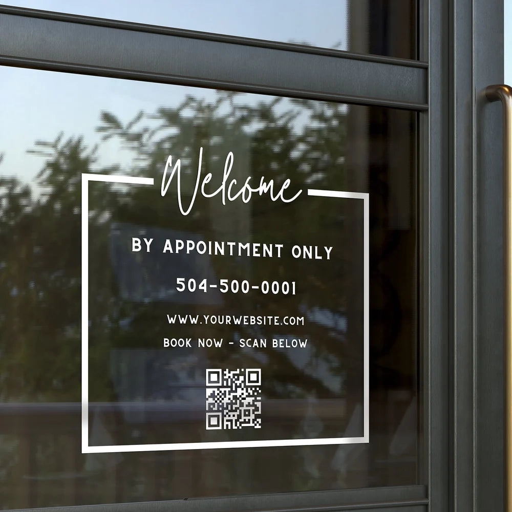 Entry door window with a vinyl decal that reads “Welcome – By Appointment Only,” including a phone number, website, and QR code for booking, framed neatly on the glass.