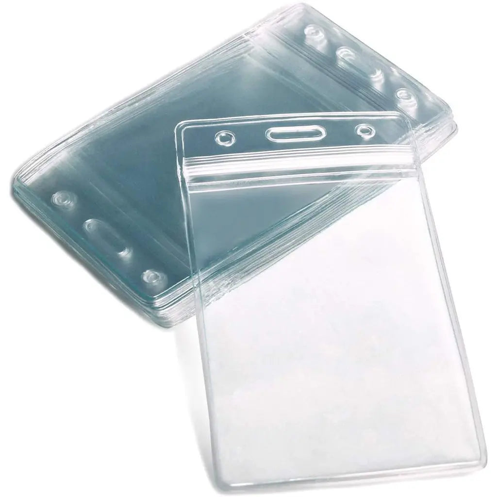 Clear plastic ID badge holders stacked together, with one holder in front showing a horizontal slot and small holes for attaching a lanyard or clip.