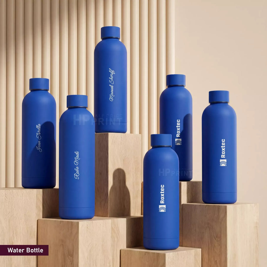 Set of blue water bottles with brand names on a wooden background