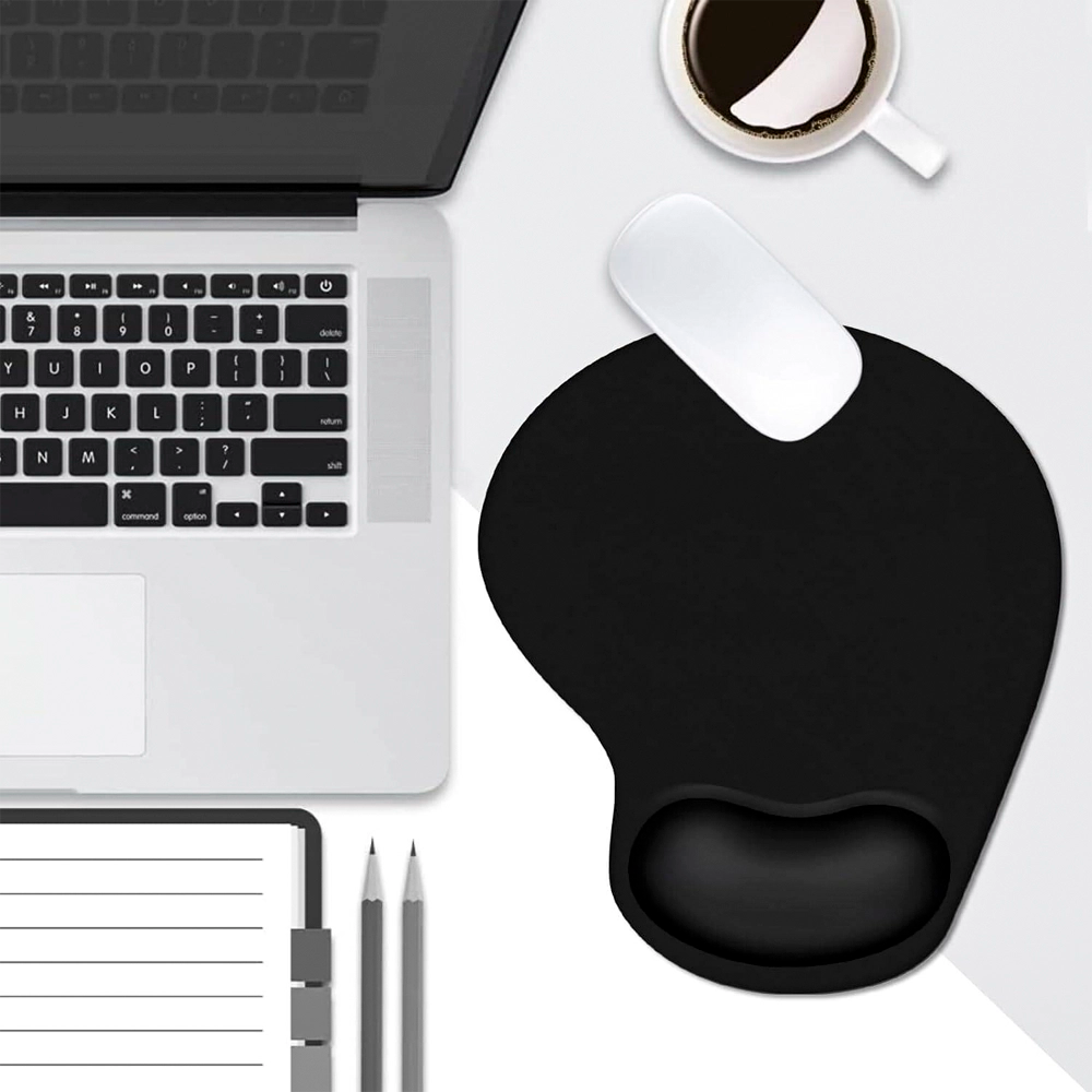 Black wrist rest on a white desk with a laptop, coffee, and stationery items.