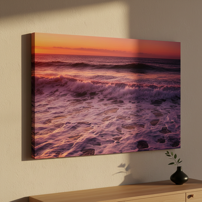 Canvas print of a sunset over the ocean hanging on a wall.