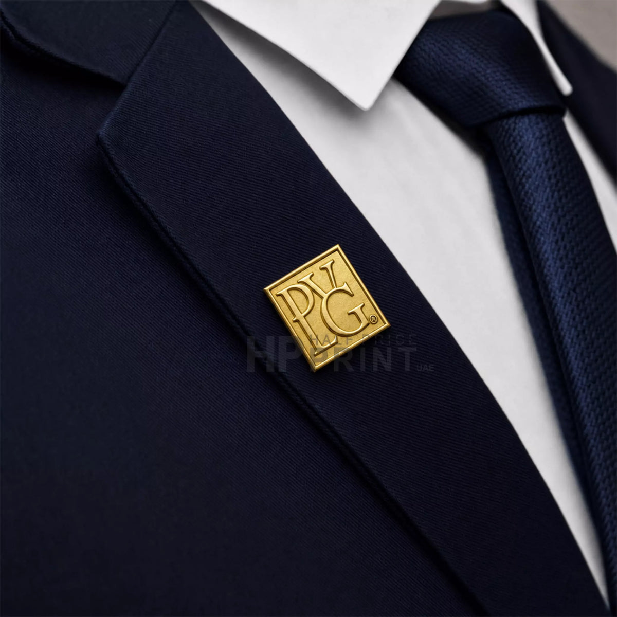 Navy suit with a gold company logo lapel pin