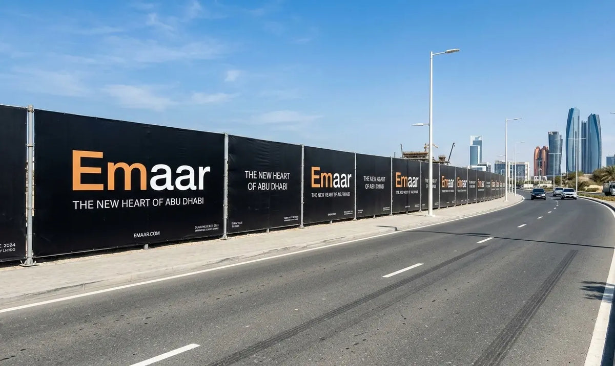 Emaar construction site fence with city skyline in the background