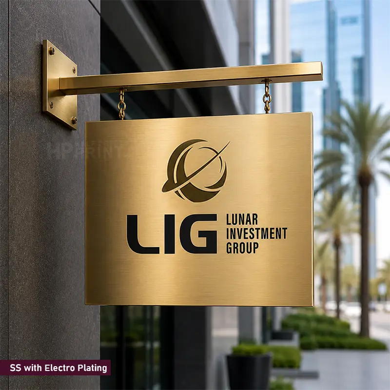 A rectangular brushed gold metal sign hanging from a gold horizontal bracket mounted on a dark building wall. The sign features a black logo and the text 'LIG LUNAR INVESTMENT GROUP'.