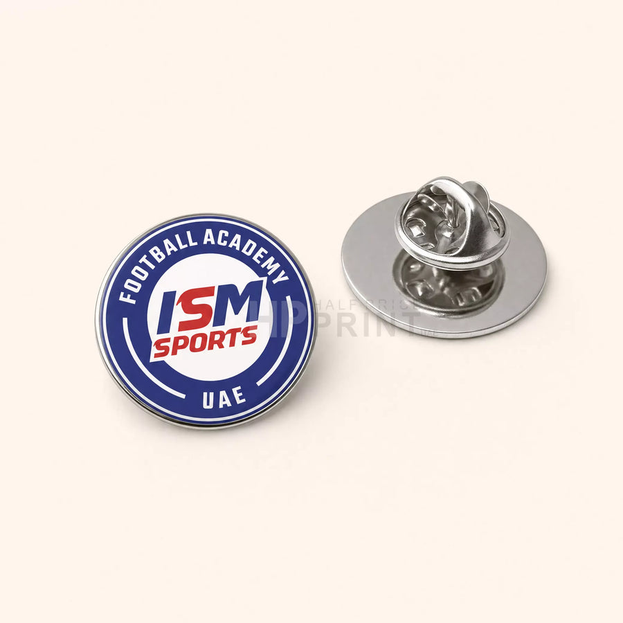 ISM Sports Football Academy lapel pin on a white background