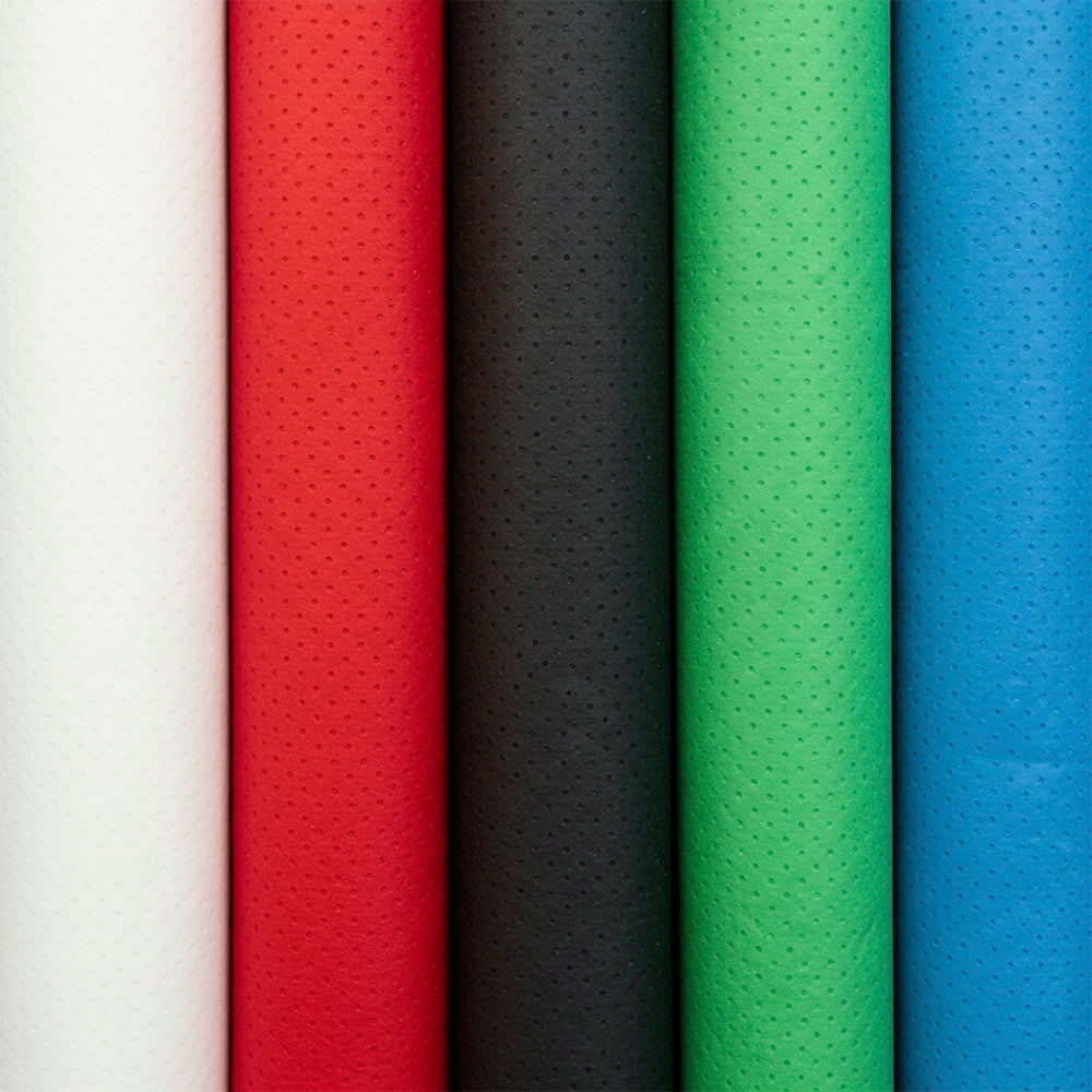 Five rolls of textured fabric in white, red, black, green, and blue.