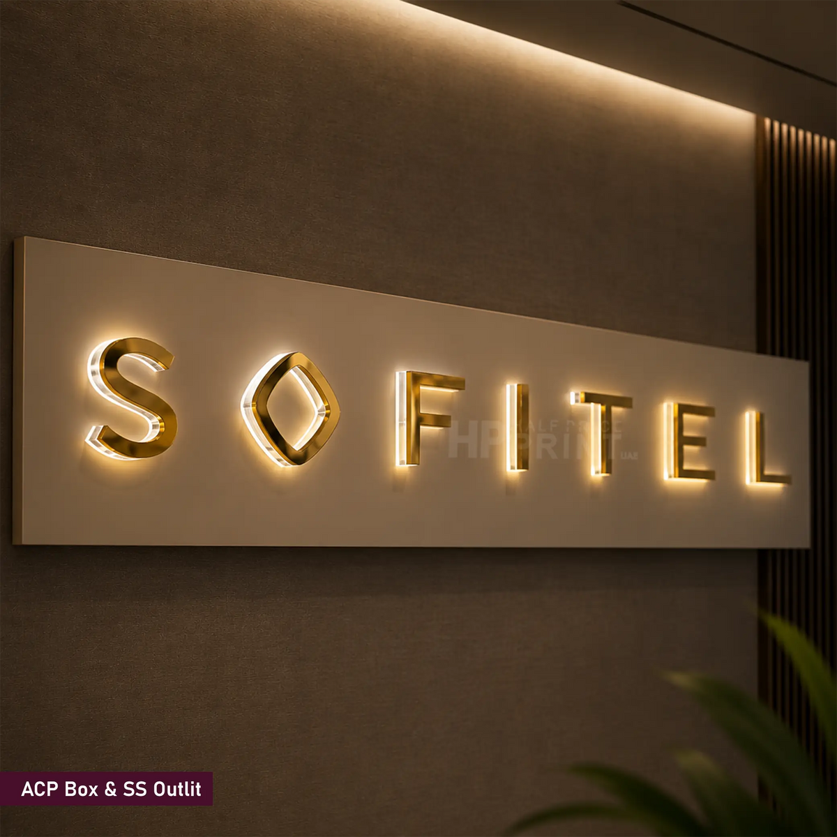 A push through sign displaying the brand name 'SOFITEL' in gold metallic letters on a rectangular light box mounted on a dark textured wall.