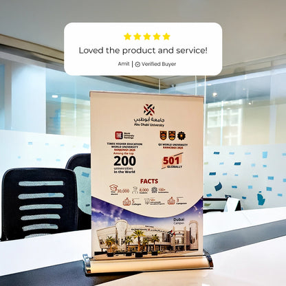 Roll-up banner with university information and customer feedback in a modern office setting.