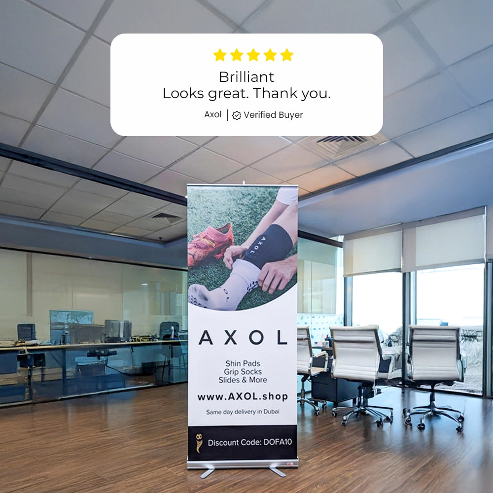 Roll-up banner in an office with a 5-star review displayed.