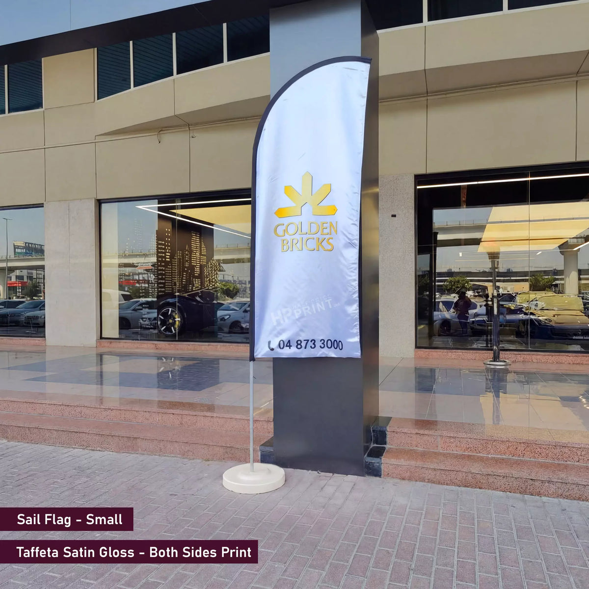 Sail flag with Golden Bricks logo in front of a building
