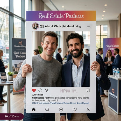 Two men holding a photo frame with 'Real Estate Partners' branding in an indoor setting.