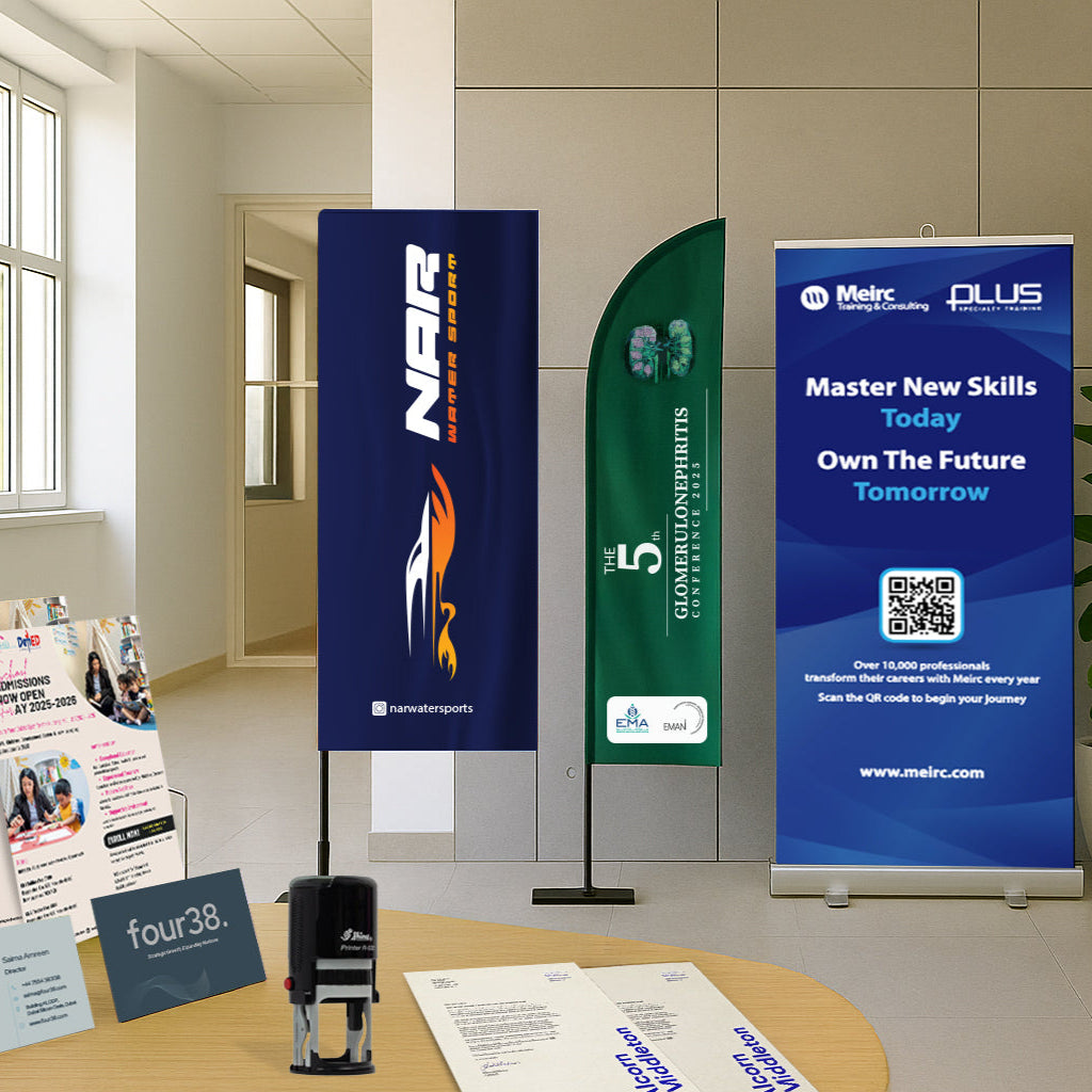 Promotional materials including banners and brochures on a table in an office setting.
