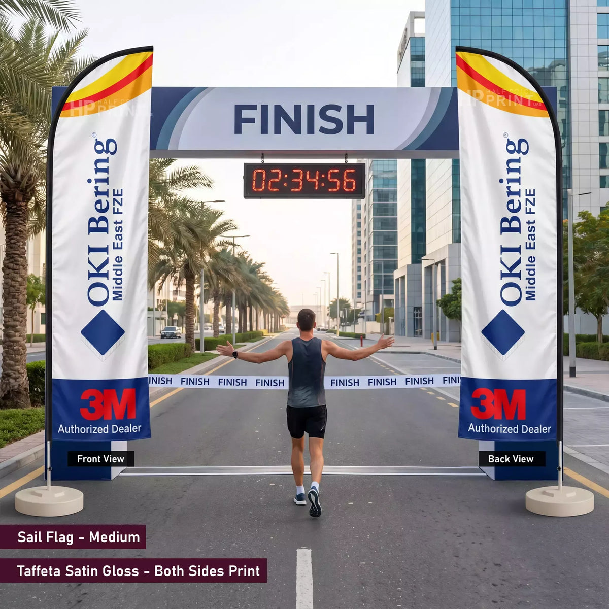 Man crossing a finish line with OKI Bering and 3M branding on sail flags.