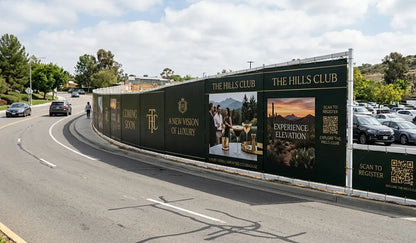 Large outdoor advertisement for 'The Hills Club' on a fence along a road.