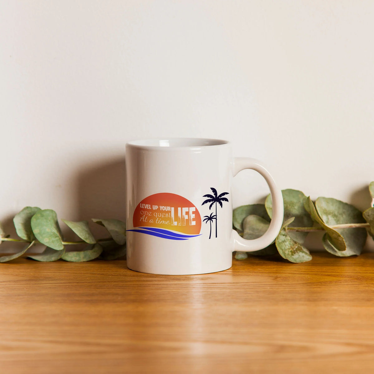Custom printed ceramic mug with motivational sunset and palm tree design on wooden table