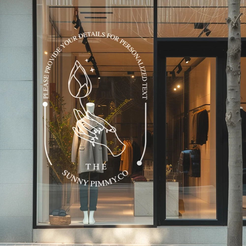 Custom window sticker applied on a glass surface, featuring text and a logo, with a mannequin visible in the background.